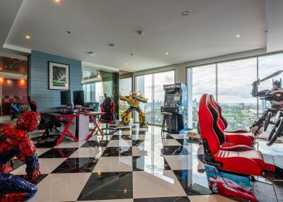 Entertainment room with gaming setups and action figure displays