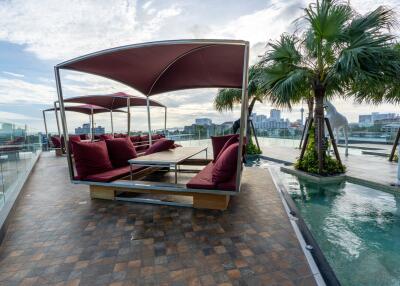 Rooftop outdoor area with seating and pool