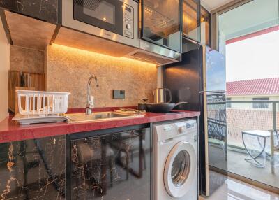 Modern kitchen with black marble countertop and open balcony