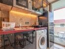 Modern kitchen with black marble countertop and open balcony