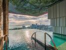 Outdoor infinity pool with city skyline view