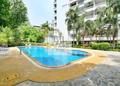 Swimming pool with surrounding patio and greenery