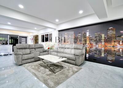 Modern living room with cityscape wall art and gray sofas