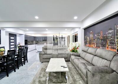 Modern living room with grey sofa and cityscape wall art
