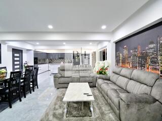 Modern living room with grey sofa and cityscape wall art