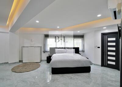 Modern bedroom with marble flooring, ceiling lights, and a large bed