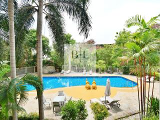 Luxurious outdoor pool area surrounded by greenery