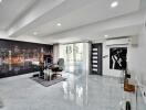 Modern living room with cityscape wall art, glass desk, and large sliding door