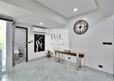 Modern hallway with wall art and a clock