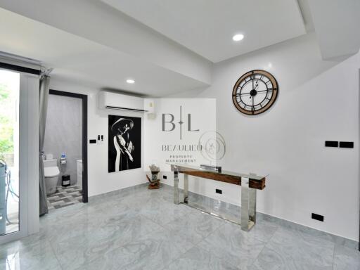 Modern hallway with wall art and a clock