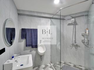 Modern bathroom with glass shower enclosure and vanity