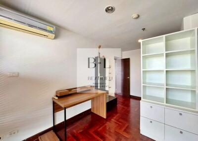Modern room with wooden flooring and white shelving unit