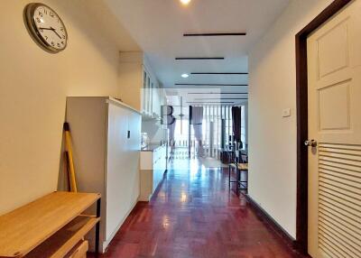 Spacious hallway with wooden flooring and storage cabinets