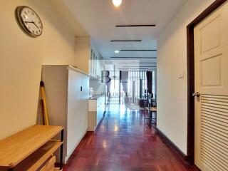 Spacious hallway with wooden flooring and storage cabinets