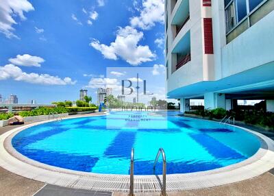 Outdoor swimming pool with cityscape background