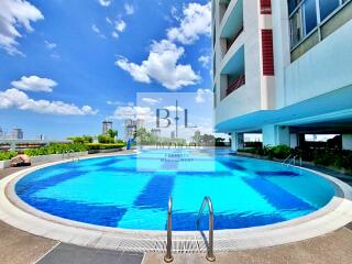 Outdoor swimming pool with cityscape background