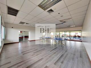 Spacious recreation room with ping pong table and large windows