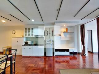 Modern kitchen area with dining table and wooden flooring