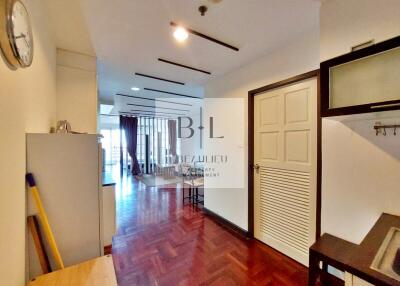 Spacious and bright main living area with wooden floor and access to balcony