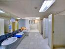 A spacious bathroom with multiple sinks and stalls