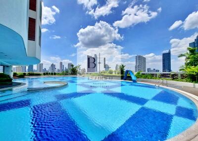 Outdoor swimming pool with city skyline view
