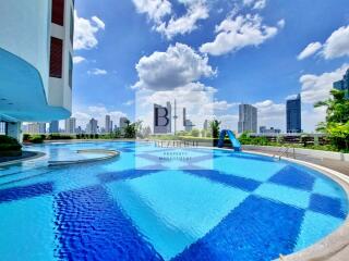 Outdoor swimming pool with city skyline view