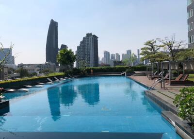 Outdoor pool area with city skyline view