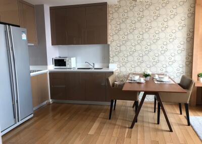 Modern kitchen and dining area with wooden flooring