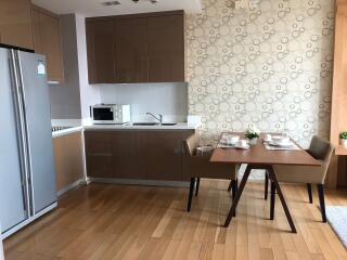 Modern kitchen and dining area with wooden flooring