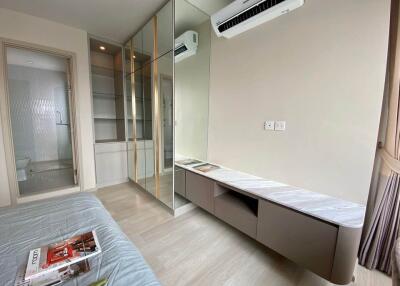Modern bedroom with built-in closet, air conditioning, and attached bathroom.