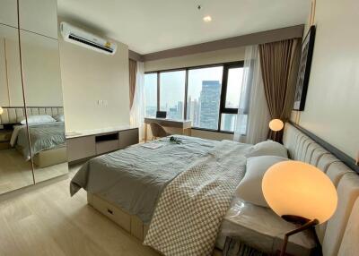 Spacious modern bedroom with a city view, double bed, ambient lighting, air conditioning, and large window