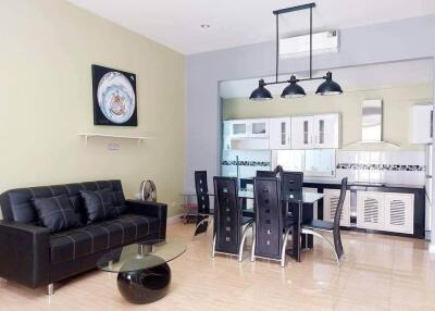 Modern open-concept living room and kitchen with stylish furniture and wall decorations