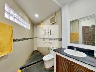 Modern bathroom with sink, mirror, and shower area