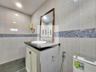 Modern bathroom with a vanity, mirror, and toilet