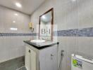 Modern bathroom with a vanity, mirror, and toilet