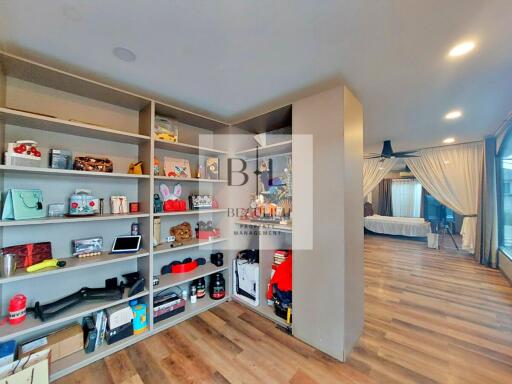 Main bedroom with shelves and large windows