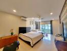 Spacious and well-lit bedroom with a large bed, air conditioning, and a balcony view.