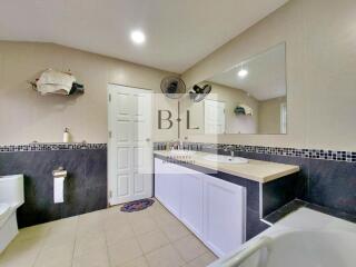 Spacious bathroom with large mirror and modern fixtures