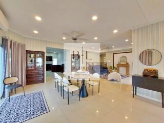 Spacious, well-lit living room with dining area and modern decor