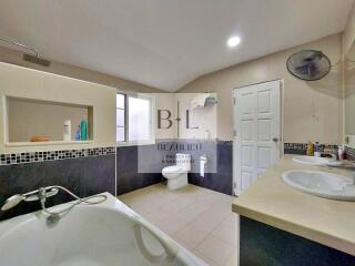 Modern bathroom with large bathtub and double sinks