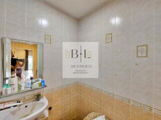 Bathroom with wall tiles and sink