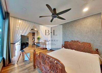 Spacious bedroom with wooden bed and modern decor