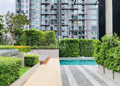 Modern residential complex with pool and greenery