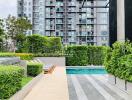 Modern residential complex with pool and greenery