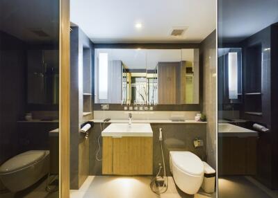 modern and luxurious bathroom with large mirror and sleek fixtures