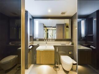 modern and luxurious bathroom with large mirror and sleek fixtures