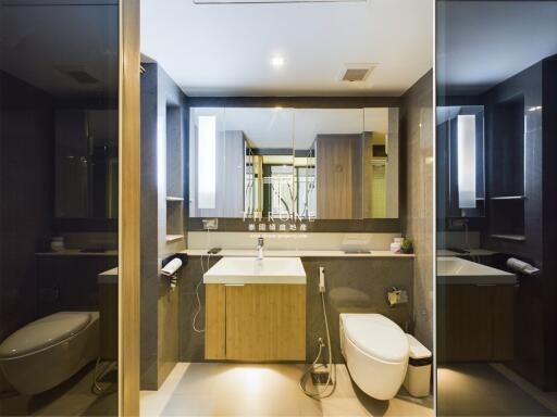modern and luxurious bathroom with large mirror and sleek fixtures