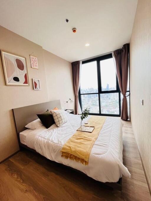 Spacious bedroom with a large window and double bed