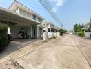 Street view of residential houses with driveways and garages