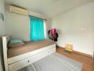 bedroom with a trundle bed and wooden flooring